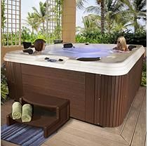 a large hot tub sitting on top of a wooden floor