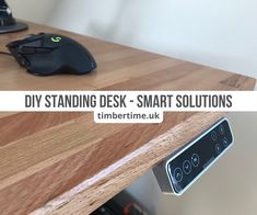 a computer mouse sitting on top of a wooden desk with the words diy standing desk - smart solutions