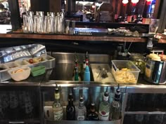 the bar is stocked with bottles of alcohol and condiments, along with other drinks