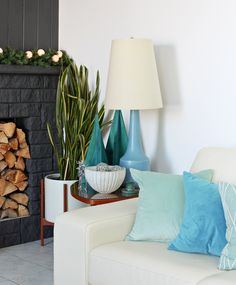 a living room filled with furniture and a fire place next to a wall mounted fireplace