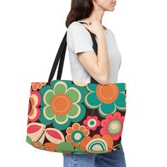 "Retro Hippie Weekender Tote Bag.  Vintage Design in groovy throwback colors and its roomy!  Groovy Retro Flower Weekender tote bag.  Throwback colors of orange, blue, green, and pink encase this sturdy vacation bag.  Great catch-all for those events when you need to bring things along.   Perfect for the hippy boho lover.  This personalized weekender bag comes in one size - 24\" x 13\" (60.9 cm x 33 cm) - perfect for those who love to travel light. Its t-bottom construction and black handles give it a sleek, classic look. Design is on 100% spun polyester in vibrant colors. .: 100% Spun Polyester .: One size: 24\" x 13\" (60.9 cm x 33 cm) .: Black interior lining .: T-bottom construction .: All-over print .: Assembled in the USA from globally sourced parts Visit our shop for more bags and a Retro Green Shoulder Bag With Large Capacity, Retro Green Everyday Bag, Green Retro Everyday Bag, Retro Green Tote Shoulder Bag, Retro Green Tote Bag, Green Retro Shoulder Bag For Shopping, Retro Green Shopping Bag, Retro Multicolor Shoulder Bag For Daily Use, Multicolor Large Capacity Bags For Weekend