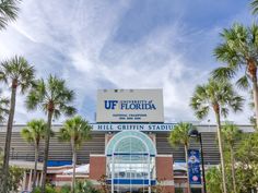 the university of florida stadium sign is shown in front of palm trees