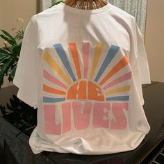 He Lives Easter Graphic Tee Gildan Size Large Brand New Never Worn Easter Holiday Christian Tee Shirt New Condition All Items Shipped 1-3 Days Smoke Free Pet Free Home Christian T Shirt Design Ideas, Sublimation Designs For Shirts Women, Cute Christian Tshirt, Cute Trendy Shirts, Cute Christian Graphic Tees, Graphic Christian Tees, Cute Jesus Shirts, Cute Christian T Shirts, Cute Christian Clothes