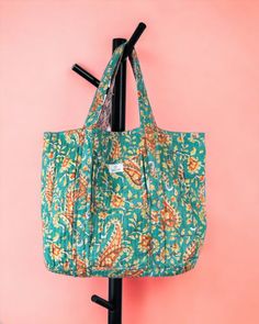 This two-in-one tote features stunning, traditional handblock prints on durable cotton fabric, allowing you to switch up your look with a simple flip. One side displays a vibrant pattern, while the reverse offers a complementary design, giving you the flexibility to match your bag with any outfit. Size: 38 X 40 X 13 cm Complementary Design, Reversible Tote Bag, Reversible Tote, Block Print, Cotton Fabric, Tote Bag, Fabric, Pattern, Design