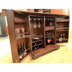 a wooden cabinet with wine glasses and bottles in it