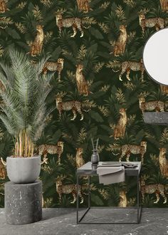 a wallpaper with leopards and palm leaves in the background, along with a round mirror