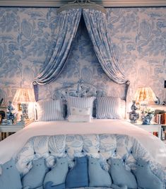 a bed with blue and white decor in a bedroom