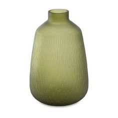 a green vase sitting on top of a white table