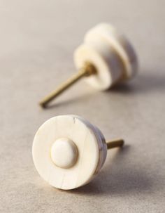 two white knobs are sitting next to each other