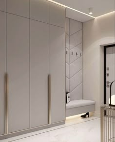 a white and gold bathroom with marble flooring, mirrored walls and cabinetry on the wall