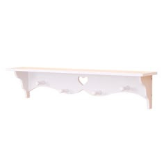 a white shelf with two hearts on the top and one heart cut out at the bottom