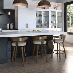 a kitchen with three stools and two lights over the island in front of it