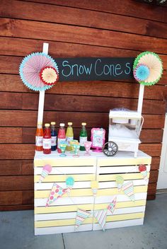 an ice cream stand with umbrellas and drinks