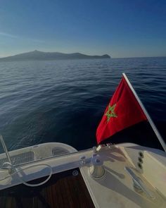 a flag on the back of a boat in the water