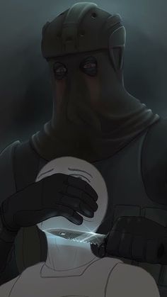 a man in a gas mask holding a white object with his hands and looking at it