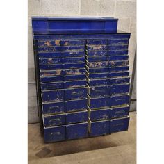 an old blue metal cabinet with many drawers