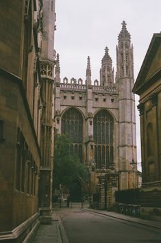 an old cathedral is seen in the distance from another building with tall spires on either side