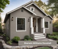 a gray house with white trim and steps leading up to the front door is shown