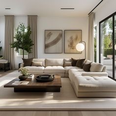 a living room filled with lots of furniture and large window covered in curtains next to a wooden coffee table