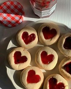 heart shaped cookies on a plate with jam