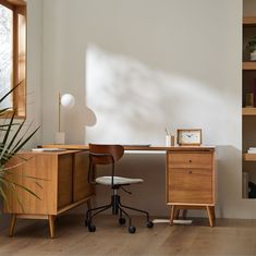 a desk with a chair and a clock on it