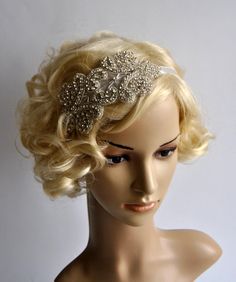 a mannequin head with a hair piece on it's head, wearing a tiara