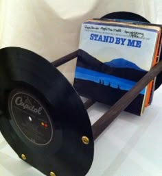 an old record player sitting on top of a table next to a vinyl album cover