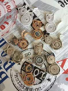 several pieces of paper with spirals on them sitting on top of a piece of newspaper