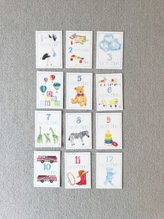 a group of cards with animals and numbers in them on a gray carpeted surface