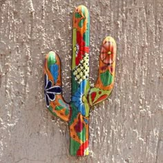 a colorful painted cactus on the side of a building