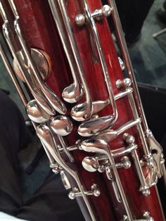 a close up view of a red instrument with metal details on the body and sides