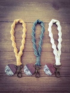 three lanyards are shown on a wooden table