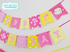 pink and yellow birthday banner with monkey on it