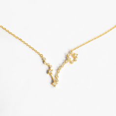 a gold necklace with the letter y on it's side and diamonds in the middle