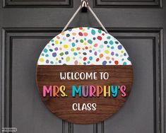 a welcome sign hanging on the front door of a house that says, welcome to mrs murphy's class