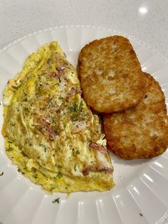 an omelet and some fried bread on a white plate