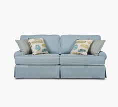 a light blue couch with two pillows on it's back and one arm facing the camera