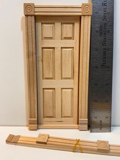 a wooden door is next to a ruler