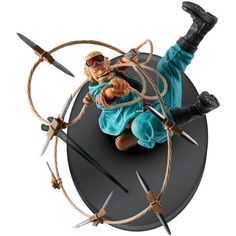 an action figure is posed on top of a circular object with swords and ropes around it