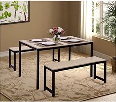 a dining table with two benches in front of it and a potted plant on the other side