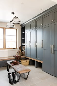 a bench sitting in the middle of a room with lots of cupboards on it