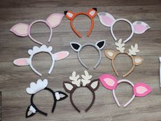 several different types of animal headbands laid out on a wooden floor next to each other