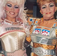 two women dressed in costumes standing next to each other