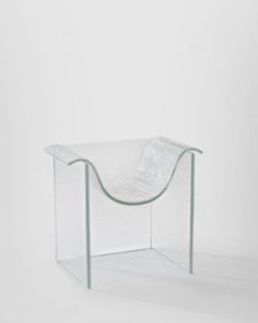 a chair made out of plastic sitting on top of a white floor