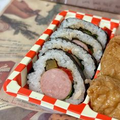 sushi is served in a red and white tray