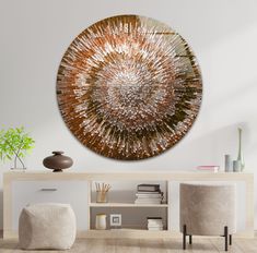 a living room with white walls and wooden flooring has a large metal art piece on the wall