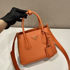 SHOP MORE LUXURY PRODUCTS HERE Description Prada Double Saffiano Mini Bag Orange For Women, Women’s Bags 9.8in/25cm 1BG443_2A4A_F0049_V_XOO Sophisticated, subtle details bring new life to the brand’s iconic designs like the Prada Double bag with its new versatile and sophisticated mini design. Iconic metallic lettering adorns the front, while a removable shoulder strap allows the bag to be worn over the shoulder or as a crossbody bag. Size: 25 x 18.5 x 12.5 cm /9.8 x 7.3 x 4.9 inches Prada Double Bag, Metal Lettering, Prada Re Edition, Louis Vuitton Shirt, Triangle Bag, Fabric Handbags, Luxury Products, Orange Bag, Belt Accessories