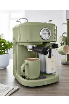 an espresso machine sitting on top of a wooden table