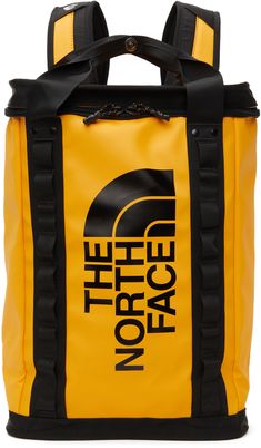 Water-repellant laminated backpack in yellow. Logo printed in black at front. · Twin webbing carry handles in black with press-stud fastening at top · Textile mesh zippered pocket and patch pocket at single-compartment interior · Adjustable padded shoulder straps featuring cinch-strap fastening, D-ring hardware, and adjustable sternum strap with press-release fastening · Technical canvas lining in black · H19 x W16 x D6 in Supplier color: Summit Gold/TNF Black Mens Backpack Fashion, Camping Materials, Modern Backpack, Commuter Backpack, Adventure Backpack, Branded Phone Cases, Sac Lunch, Accessories Packing, Recycled Canvas