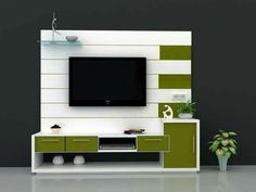 an entertainment center with a flat screen tv mounted on the wall and green cabinet doors